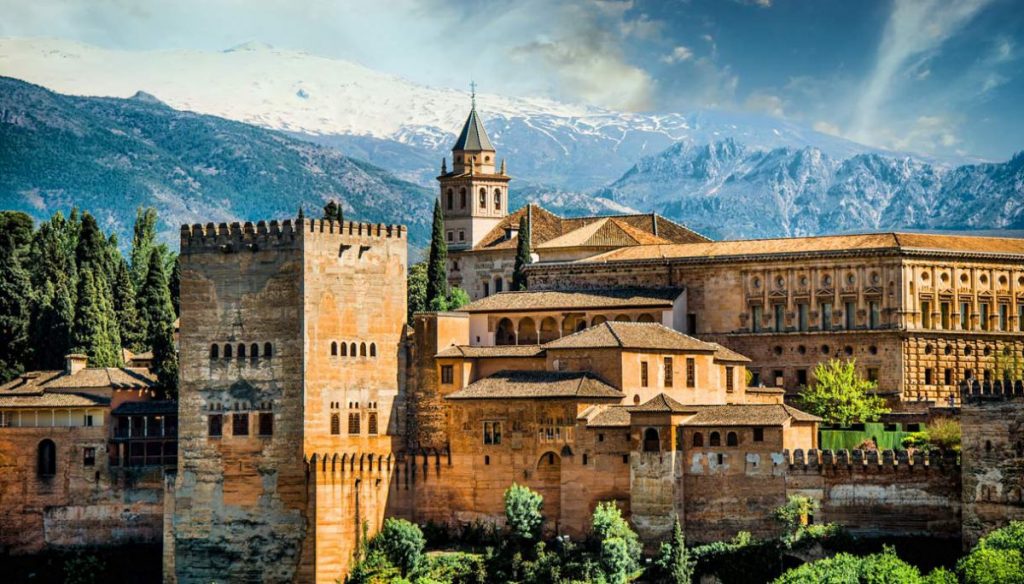 A view of the Alhambra with snow-capped mountains behind