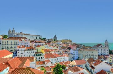 get a shuttle to the red roofs of Lisbon