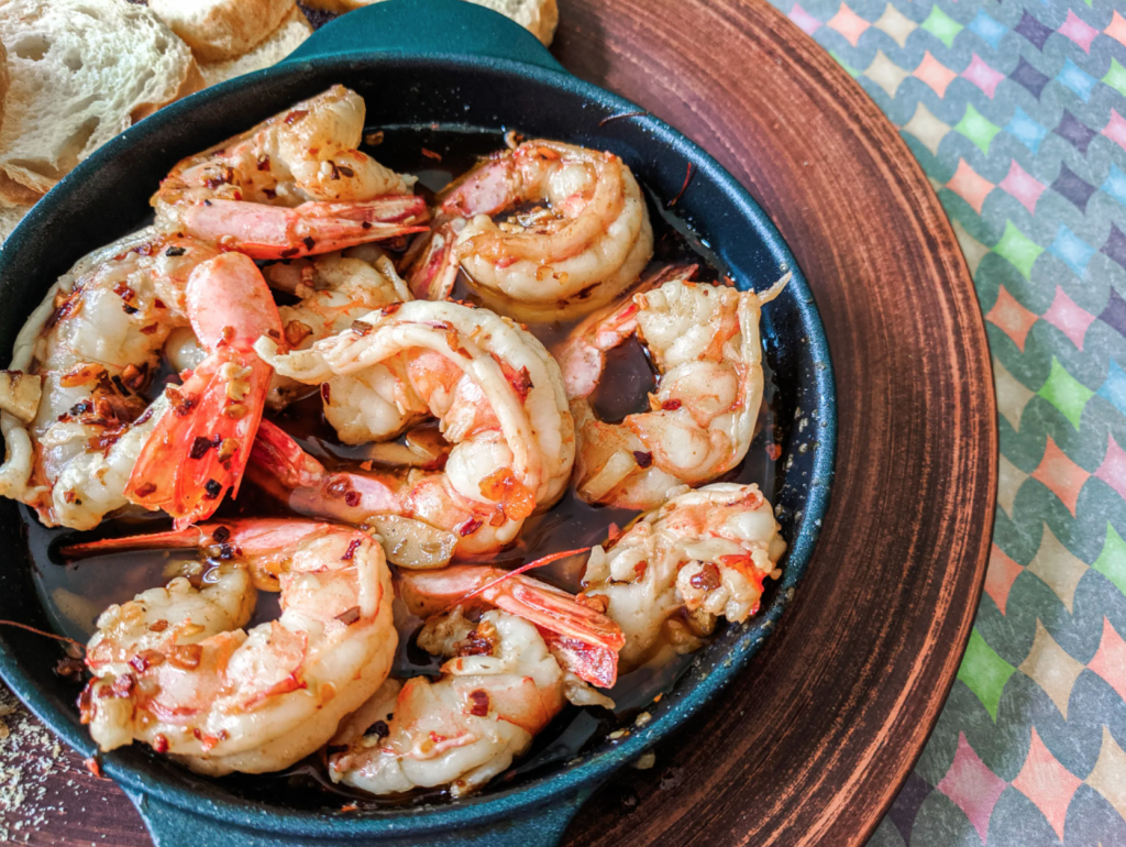 Gambas Al Ajillo in a black skillet. PC - Cookingtoentertain.com