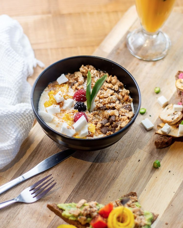 Fresh Granola bowl with fruit and a side of avocado toast